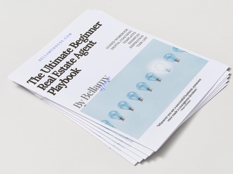 May include: A stack of white paperbacks titled "The Ultimate Beginner Real Estate Agent Playbook" by Bellamy. The cover features light bulbs and text. The book is designed for real estate agents.