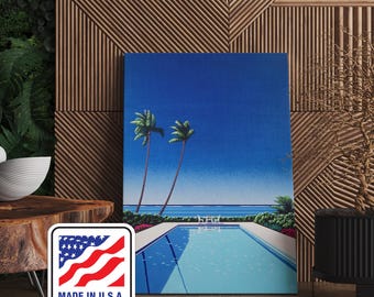 May include: A canvas print featuring a tropical scene with a swimming pool, palm trees, and a clear blue sky. The artwork has a retro aesthetic. The print is labeled "MADE IN U.S.A." in a white and red emblem.