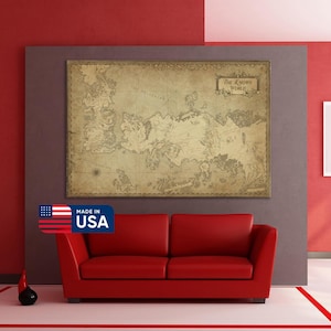 May include: A large, framed vintage map of "The Known World" in sepia tones hangs above a red leather sofa. The map features intricate details and a classic aesthetic. The image includes a "Made in USA" sticker.