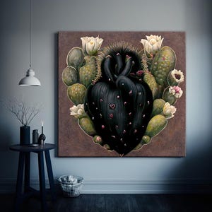 May include: A large square canvas art piece featuring a stylized black cactus heart shape surrounded by green cacti and white flowers. The artwork is set against a brown background and hangs on a light gray wall.