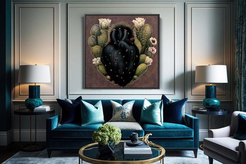 May include: A framed artwork featuring a black heart-shaped cactus surrounded by green cacti and white flowers. The artwork hangs above a teal sofa with teal and navy blue pillows. Two teal lamps with white shades flank the sofa.