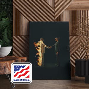 Puede incluir: Impresi&oacute;n en lienzo que muestra a dos figuras d&aacute;ndose la mano sobre un fondo oscuro. Una figura est&aacute; en llamas, la otra con un traje verde. La impresi&oacute;n se muestra en una pared de madera con una pegatina "MADE IN U.S.A.".