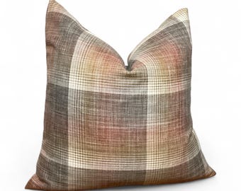 May include: A decorative square pillow with a plaid pattern in shades of brown, beige, and gray. The pillow has a soft, textured appearance and is designed for home decor. The plaid design adds a classic touch to any living space.