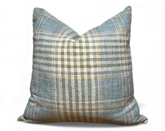May include: Square decorative pillow with a plaid pattern in shades of blue, beige, and gray. The pillow has a soft, textured appearance and a classic design, suitable for home decor.
