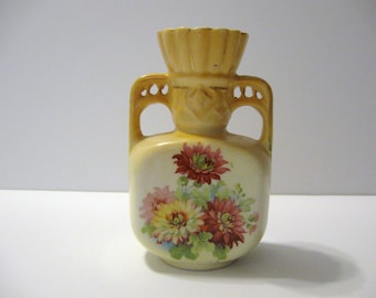 Vintage Austrian porcelain vase with flowers on front and yellow glaze