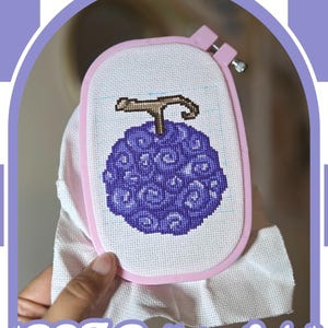 May include: A cross-stitch project in a light pink oval embroidery hoop featuring a purple, swirl-patterned fruit with a brown stem on white Aida cloth. The text *PDF Pattern Only* is printed in white at the bottom of the image frame.