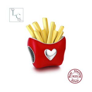 May include: A charm shaped like a red container filled with golden yellow french fries. The front of the red container features a raised silver heart. The charm includes a circular stamp that reads Real Sterling 925 Silver.