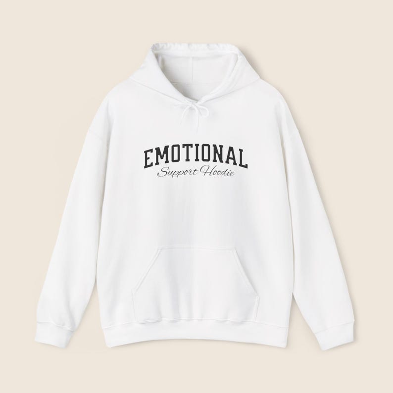 May include: A white hoodie with a front pocket and a drawstring hood. The text "EMOTIONAL" is printed above "Support Hoodie" in a black, stylized font.