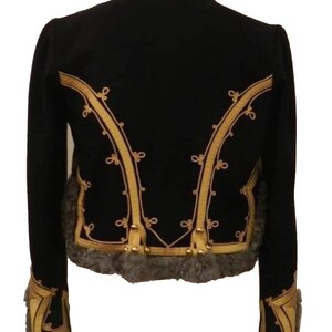 May include: Black jacket with gold embroidery and gray fur trim. The jacket features ornate gold detailing along the edges and back, with decorative tassels. The collar and cuffs are trimmed with gray fur, creating a luxurious look.
