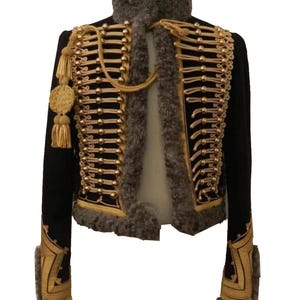May include: A black cropped jacket with gold trim and accents, including buttons, tassels, and decorative embroidery. The jacket features a high collar and faux fur trim around the neck and cuffs. A stylish military-inspired garment.