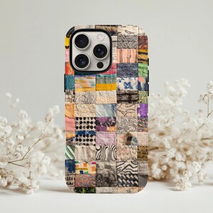 May include: A phone case with a patchwork design. The case is made up of small fabric squares in various colours and patterns. The patterns include floral, geometric, and abstract designs. The case has a black border and a camera cutout.