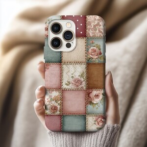 May include: A patchwork-style phone case with squares of floral and patterned fabrics in pink, blue, brown, and cream. The case has a vintage, quilted look with visible stitching and rose illustrations.