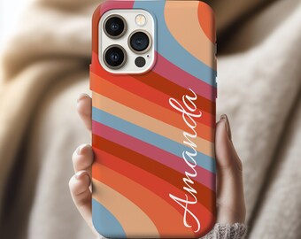 May include: A colorful phone case with a retro design. The case features diagonal stripes in shades of orange, red, pink, and blue. The name "Amanda" is written in a cursive font on the case.