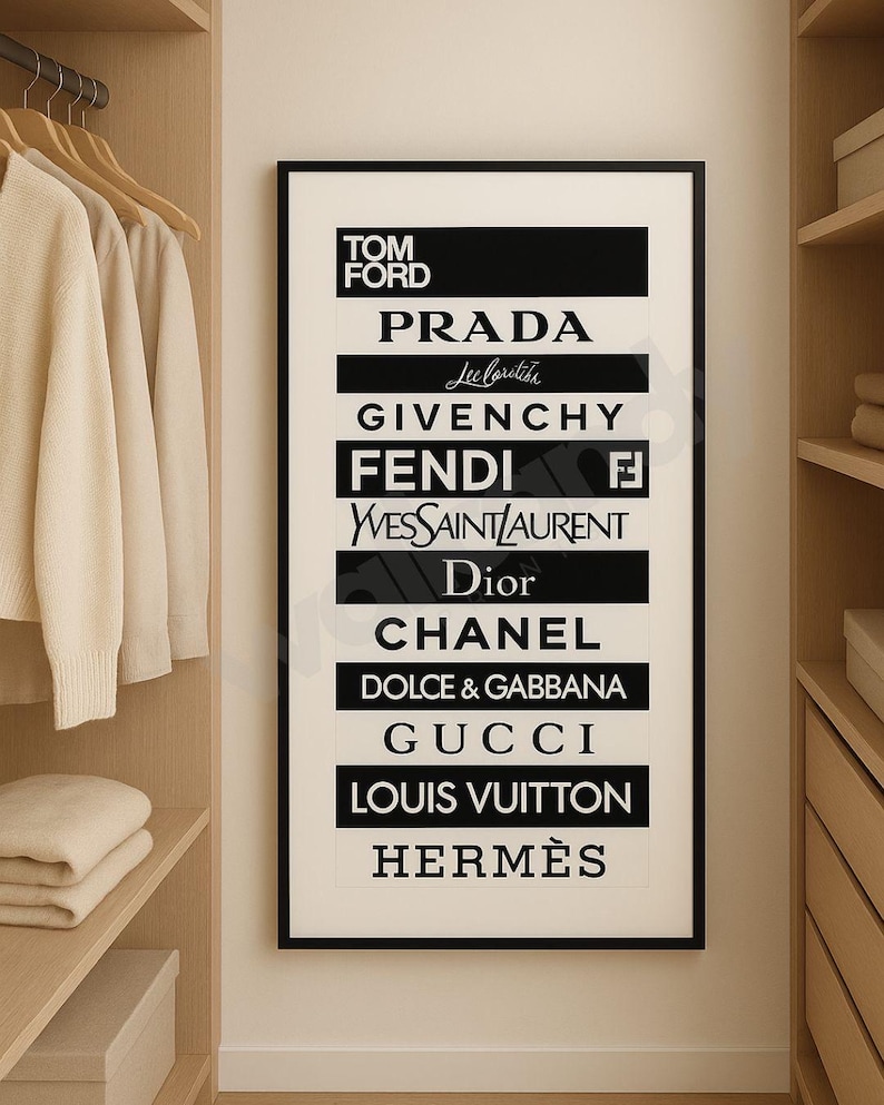May include: A framed black and white print displaying the logos of high-end fashion brands including Tom Ford, Prada, Givenchy, Fendi, Yves Saint Laurent, Dior, Chanel, Dolce & Gabbana, Gucci, Louis Vuitton, and Herm&egrave;s. The print is in a wardrobe.