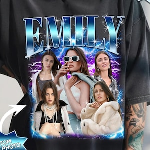 May include: Black t-shirt featuring a custom design with the name "EMILY" in a blue and white font. The design includes a collage of photos and the text "CUSTOM TEXT & PHOTO" and "PROOF IN 24 HOURS".
