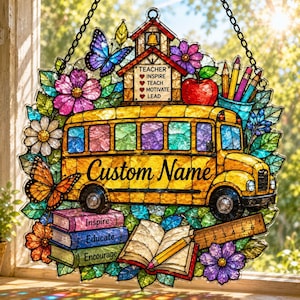 May include: A stained glass suncatcher featuring a yellow school bus with the text Custom Name, a schoolhouse with the text TEACHER INSPIRE TEACH MOTIVATE LEAD, a stack of books labeled Inspire, Educate, Encourage, a pencil, and colorful flowers.