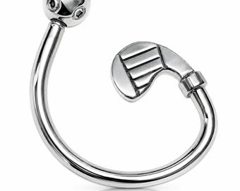 May include: A silver-toned curved barbell body jewelry piece featuring a spherical end with four small circular indentations and a golf club-shaped end with grooved detailing on the club head, crafted from a polished metallic material.