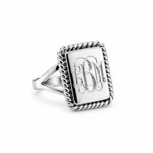 May include: A silver-toned ring featuring a rectangular face with a rope-style border. The center of the rectangular plate is engraved with a decorative script monogram featuring the letters BM. The ring has a split shank band design.