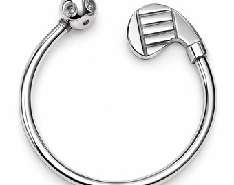 May include: A silver-toned open bangle bracelet featuring a golf club head on one end and a spherical golf ball charm on the other. The golf ball charm is detailed with small, inset clear stones, and the entire piece has a polished finish.