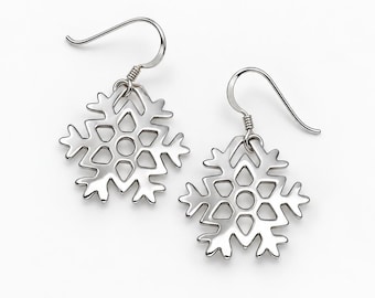 May include: A pair of silver-toned metal earrings featuring a symmetrical snowflake design with cut-out geometric shapes. Each earring is suspended from a curved hook wire, showcasing a polished finish and intricate, branching arms that form a star-like pattern.