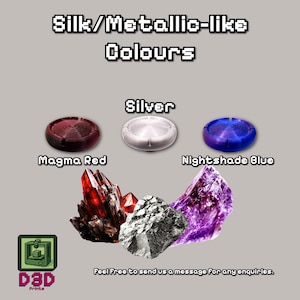 May include: Image showcasing 3D-printed items in silk/metallic-like colors. Includes Magma Red, Silver, and Nightshade Blue circular objects, along with red, silver, and purple crystal formations. The text reads "Silk/Metallic-like Colours".