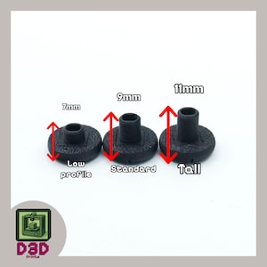 May include: Three black 3D-printed bottle stoppers with varying heights: 7mm, 9mm, and 11mm. Each stopper has a circular base and a cylindrical top. The text "Low profile", "Standard", and "Tall" are below each stopper. The D3D Prints logo is in the lower left corner.