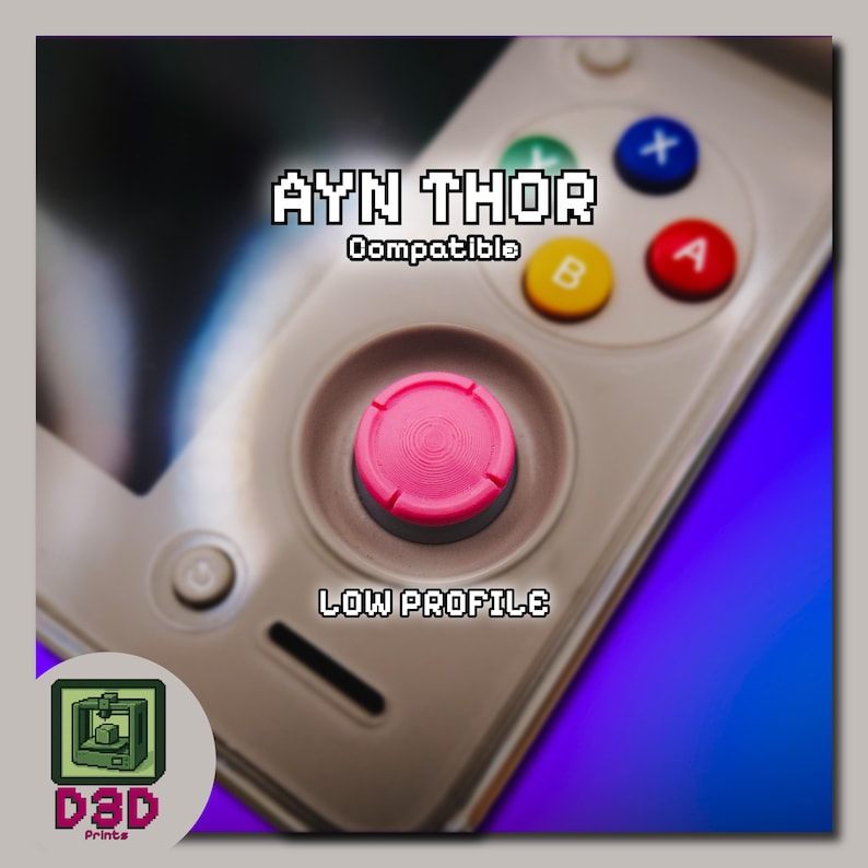 May include: A close-up of a gaming controller with a pink joystick and colorful buttons. The text "AYN THOR Compatible" and "LOW PROFILE" are displayed. A logo with the text "D3D Prints" is in the lower left corner.