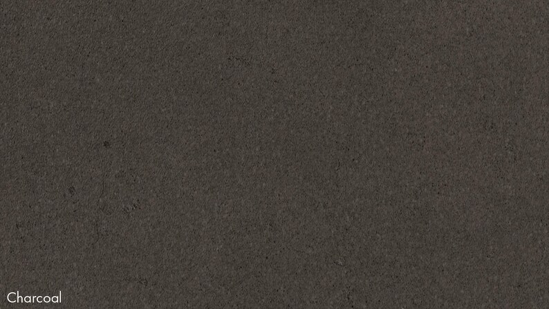 The image is a dark grey or black background with no discernible objects or text present.