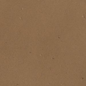 The image is a close-up of a brown surface, possibly a wall or a piece of paper, with small white specks or specks of color scattered across it.
