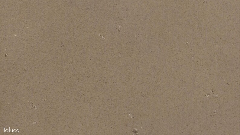 The image is a close-up of a textured surface, possibly a piece of paper or a fabric, with small white specks scattered across it.