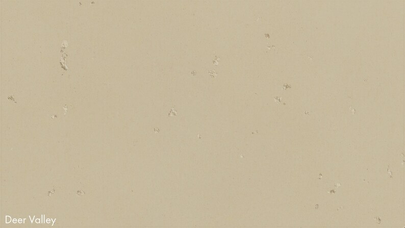 The image is a close-up of a beige surface with small white spots scattered across it.