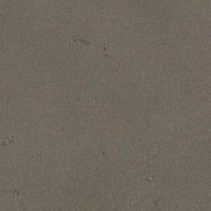 The image is a close-up of a grey, textured surface, possibly a piece of graphite or a similar material.