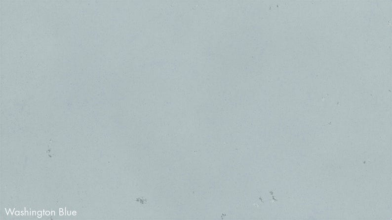 The image is a plain, light blue background with some small, white specks scattered throughout.