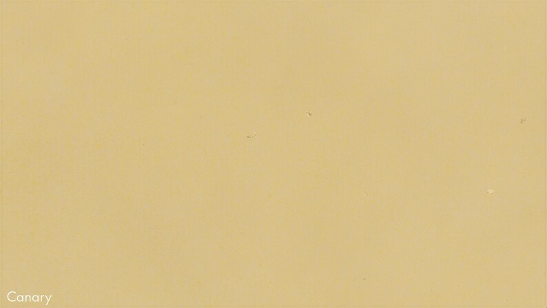 The image is a plain yellow background with no discernible objects or text.