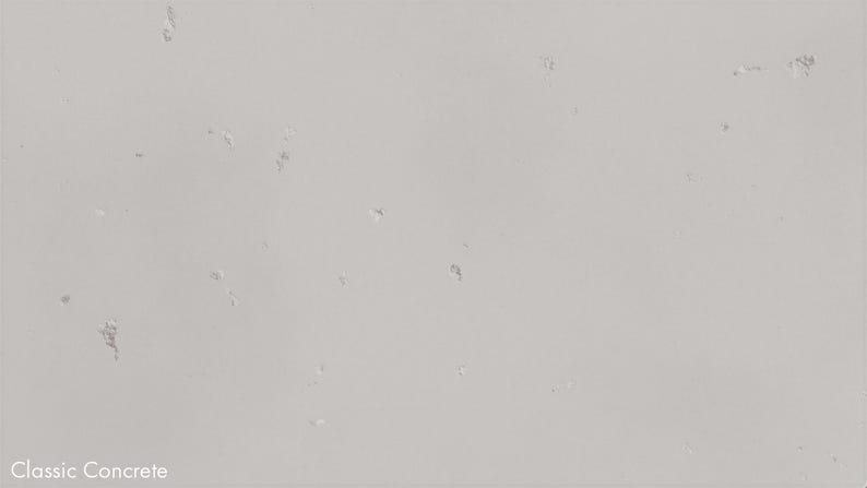 The image is a plain white surface with small white spots scattered across it.