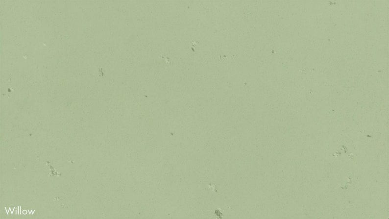 The image is a pale green color with small white spots scattered throughout, resembling a light green or minty color.