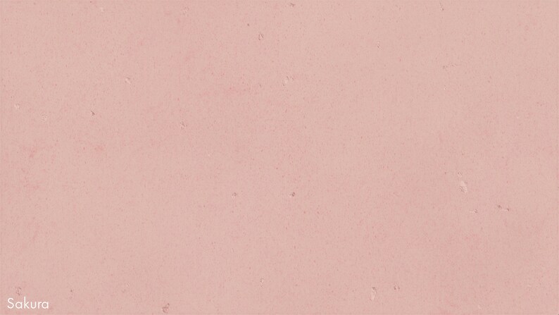 The image is a close-up of a pinkish-red surface, possibly a wall or a fabric. There are small white specks scattered across the surface, creating a textured and speckled appearance.