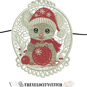 May include: Embroidered Christmas ornament featuring a cute mouse wearing a red hat and scarf, holding a red ornament. The ornament is framed by a decorative, openwork design. The text "THEVELOCITYSTITCH" is at the bottom.