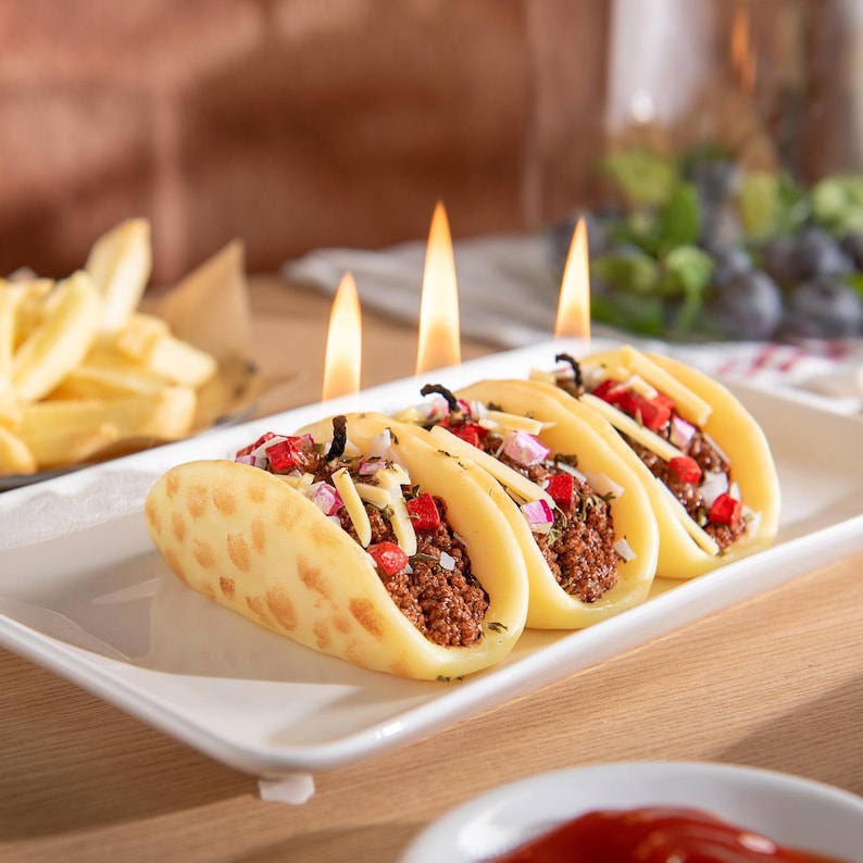 Realistic hand-poured taco candle burning on reusable plate holder, detailed soy wax food candle with shell, beef, and cheese design. Unique novelty gift for taco lovers and Mexican food décor