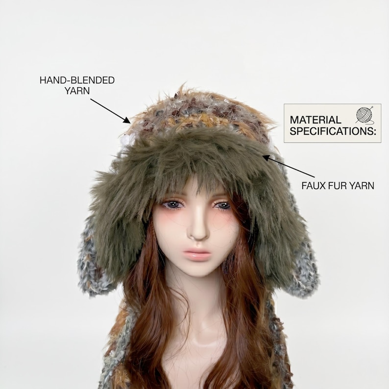 May include: A faux fur hat with ear flaps. The hat is made with hand-blended yarn and faux fur yarn. The hat has a mix of brown, gray, and green colors. The text on the image reads "MATERIAL SPECIFICATIONS:" and "HAND-BLENDED YARN" and "FAUX FUR YARN".