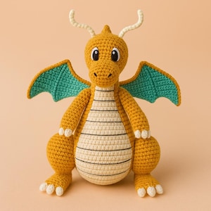 May include: A handmade crochet dragon in shades of yellow, cream, and teal. The dragon has large black eyes, cream-colored horns, and teal wings. The body is a mix of cream and yellow with black stripes.