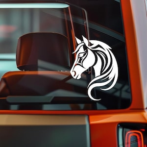 May include: White vinyl decal of a horse head with a tribal design. The horse's profile is facing left, with flowing mane and intricate details. The decal is applied to a vehicle window.