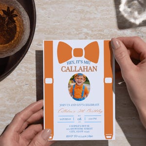 May include: A rectangular birthday invitation card featuring a large orange bow tie and suspender graphic. The text reads HEY, IT'S ME! CALLAHAN, JOIN US AND LET'S CELEBRATE, Callahan's 5th Birthday, SATURDAY 08 1:00 PM, COOPER'S HOUSE 123 ANYWHERE STREET, RSVP TO 123.456.7890.