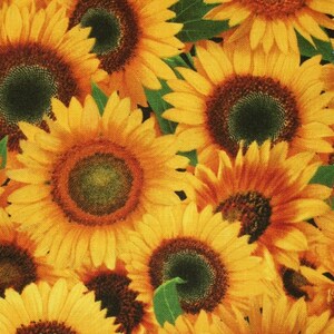 May include: A close-up image of a fabric with a pattern of yellow sunflowers. The sunflowers are in various stages of bloom, with some fully open and others still in bud. The fabric is a light yellow color with a subtle texture.