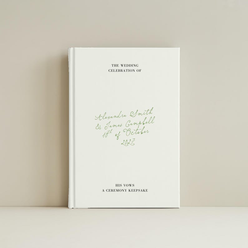 May include: A white hardback book featuring black and green text. The cover displays the words THE WEDDING CELEBRATION OF, Alexandra Smith & James Campbell 10th of October 2027, HIS VOWS, and A CEREMONY KEEPSAKE. The names and date are in green cursive.