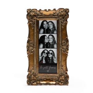May include: Ornate gold-colored picture frame with three black and white photo strips. The photos show pairs of young women. The bottom of the frame has the text "le petit frames" with a heart symbol.