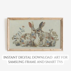 May include: A framed print depicting two rabbits with floral patterns, touching noses, amidst wildflowers. The artwork has a vintage style with a pale green backdrop and a wooden frame. The text at the bottom reads "INSTANT DIGITAL DOWNLOAD ART FOR SAMSUNG FRAME AND SMART TVS."