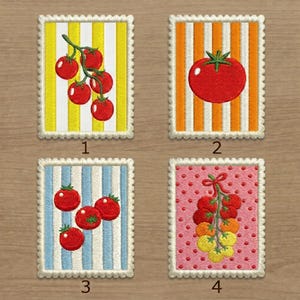 May include: Four rectangular embroidered patches with scalloped edges. Patch 1 shows red tomatoes on yellow stripes. Patch 2 features a single red tomato on orange stripes. Patch 3 displays red tomatoes on blue stripes. Patch 4 shows a cluster of tomatoes on pink polka dots.