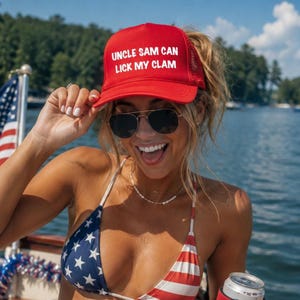 May include: A red trucker hat with the text "UNCLE SAM CAN LICK MY CLAM" in white. The hat is worn by a person wearing sunglasses and a patriotic bikini top with a red and white striped bottom and a blue top with white stars.