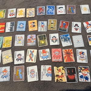 May include: A trio of ceramic mugs with a speckled, matte finish in cream, light grey, and dark grey. Each mug features a simple, minimalist design, ideal for tea or coffee.